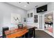 Bright office space with a unique wooden desk, TV, and views into other rooms at 17807 Arbor Greene Dr, Tampa, FL 33647