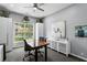 Bright office space featuring a unique wood desk, storage cabinets, and natural light at 17807 Arbor Greene Dr, Tampa, FL 33647