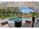 Beautiful pool and spa area with screened-in patio and a fire pit, ideal for relaxation at 17807 Arbor Greene Dr, Tampa, FL 33647