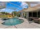 Inviting screened-in pool with a spa and lounge chairs offers a relaxing outdoor space at 17807 Arbor Greene Dr, Tampa, FL 33647