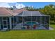 View of screened-in pool with outdoor seating, creating an ideal outdoor living space at 17807 Arbor Greene Dr, Tampa, FL 33647