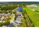 Aerial view highlighting the property's location, proximity to a pond, and community green spaces at 18508 Merseyside Loop, Land O Lakes, FL 34638