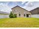Well-maintained backyard with lush grass, white fence, a patio, and mature trees at 18508 Merseyside Loop, Land O Lakes, FL 34638