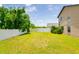 Large backyard with a well-maintained lawn and a white privacy fence, ideal for outdoor activities at 18508 Merseyside Loop, Land O Lakes, FL 34638
