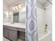 Bathroom featuring a vanity sink with a mirror, vanity lights and a shower and tub with curtain at 18508 Merseyside Loop, Land O Lakes, FL 34638
