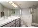 Bathroom with double vanity sinks, a walk-in shower, and a soaking tub at 18508 Merseyside Loop, Land O Lakes, FL 34638