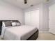 Cozy bedroom with a comfortable bed, stylish bedding, and a spacious closet for ample storage at 18508 Merseyside Loop, Land O Lakes, FL 34638