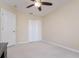 Neutral bedroom featuring a standard closet and a light-fixture fan with lights at 18508 Merseyside Loop, Land O Lakes, FL 34638