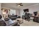 Modern living room with comfortable leather sofas, desk, and a large entertainment system at 18508 Merseyside Loop, Land O Lakes, FL 34638