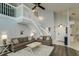 Bright and airy living room featuring high ceilings, a staircase, and elegant decor at 18508 Merseyside Loop, Land O Lakes, FL 34638