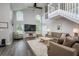 Bright, open living room with a staircase, large windows, and stylish decor at 18508 Merseyside Loop, Land O Lakes, FL 34638