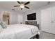 Comfortable bedroom with a TV, ceiling fan, and access to the ensuite bathroom at 18508 Merseyside Loop, Land O Lakes, FL 34638