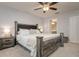 Bedroom featuring a rustic wood bed frame, neutral decor, and ensuite access at 18508 Merseyside Loop, Land O Lakes, FL 34638