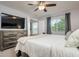 Spacious bedroom featuring a dresser, TV, and window with natural light at 18508 Merseyside Loop, Land O Lakes, FL 34638