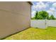 Side yard with healthy green lawn and a secure white privacy fence, offering additional outdoor space at 18508 Merseyside Loop, Land O Lakes, FL 34638