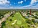 Aerial view of the home with proximity to the lush golf course and surrounding neighborhood at 18549 Grand Club Dr, Hudson, FL 34667