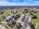 Aerial view of the community, including the clubhouse, pool, golf course, tennis and pickleball courts at 18549 Grand Club Dr, Hudson, FL 34667