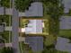 Aerial view showcases a residential property with a well maintained lawn and mature trees at 18549 Grand Club Dr, Hudson, FL 34667