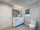 Bright bathroom featuring a double sink vanity, large mirror, and neutral color palette at 18549 Grand Club Dr, Hudson, FL 34667