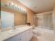 Bathroom featuring a shower and tub combo, along with a single sink vanity and storage at 18549 Grand Club Dr, Hudson, FL 34667