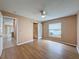 A spacious bedroom features a ceiling fan, a modern sliding door to the bathroom, and wood-look flooring at 18549 Grand Club Dr, Hudson, FL 34667