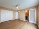 Bedroom featuring wood-look flooring, a ceiling fan, a walk-in closet and an en-suite bathroom with a sliding door at 18549 Grand Club Dr, Hudson, FL 34667