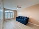 Bedroom with laminate flooring, a ceiling fan, and large windows with shutter coverings at 18549 Grand Club Dr, Hudson, FL 34667