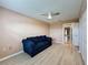 Bedroom featuring a ceiling fan, laminate flooring, and closet storage in a neutral palette at 18549 Grand Club Dr, Hudson, FL 34667