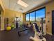 Brightly lit exercise room with workout machines and a large window offering scenic views of the community at 18549 Grand Club Dr, Hudson, FL 34667
