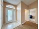 Inviting foyer with a decorative glass front door, tiled flooring, and views into adjacent living spaces at 18549 Grand Club Dr, Hudson, FL 34667