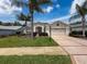 Beautiful home with an attached two car garage, beautiful shrubbery and luscious green lawn at 18549 Grand Club Dr, Hudson, FL 34667