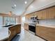 Kitchen features stainless appliances, granite countertops, and a view of the breakfast area at 18549 Grand Club Dr, Hudson, FL 34667