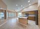Open kitchen area features island with sink, stainless steel appliances, and bright natural lighting at 18549 Grand Club Dr, Hudson, FL 34667