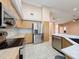 Bright kitchen with stainless steel appliances, tile flooring, and convenient access to living area at 18549 Grand Club Dr, Hudson, FL 34667