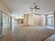 Spacious living room with wood floors, fan, and plenty of natural light from sliding glass doors at 18549 Grand Club Dr, Hudson, FL 34667