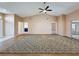 Open-concept living room boasting high ceilings, neutral walls, and an inviting atmosphere with seamless access to other rooms at 18549 Grand Club Dr, Hudson, FL 34667