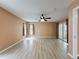 Large living room with wood flooring, a ceiling fan, and sliding doors to outdoor area at 18549 Grand Club Dr, Hudson, FL 34667