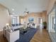 Bright living room featuring vaulted ceilings, hardwood floors, comfortable seating, and sliding doors to the outside at 18549 Grand Club Dr, Hudson, FL 34667