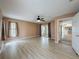 Open living area showcasing wood floors, large windows, and access to kitchen at 18549 Grand Club Dr, Hudson, FL 34667