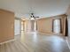 Spacious living room with luxury vinyl floors, a ceiling fan, and two windows at 18549 Grand Club Dr, Hudson, FL 34667