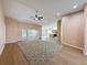Open-concept living room features a ceiling fan, wood floors, and seamless access to kitchen at 18549 Grand Club Dr, Hudson, FL 34667