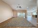 Spacious living room featuring vaulted ceilings, wood flooring, and natural light streaming in from large sliding glass doors at 18549 Grand Club Dr, Hudson, FL 34667