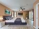 Spacious main bedroom with luxury flooring, ceiling fan, and a sliding glass door at 18549 Grand Club Dr, Hudson, FL 34667