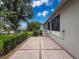 Exterior patio space with mature hedges offering privacy and access to the house at 18549 Grand Club Dr, Hudson, FL 34667
