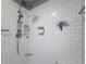Close-up of shower with white subway tile, dual shower heads, and built-in niche at 18549 Grand Club Dr, Hudson, FL 34667