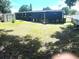 A large backyard, shed, and patio are perfect for outdoor living and entertaining at 2010 Warrington Way, Tampa, FL 33619