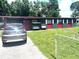 Quaint single-story home with a well-manicured front yard and covered parking at 2010 Warrington Way, Tampa, FL 33619