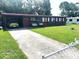 Charming single-story home with a well-maintained lawn and swing, providing a welcoming curb appeal at 2010 Warrington Way, Tampa, FL 33619