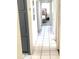 Hallway featuring tiled floors and leads towards the bedroom at 2010 Warrington Way, Tampa, FL 33619