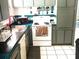 Cozy kitchen featuring white appliances, teal countertops, and ample cabinet space at 2010 Warrington Way, Tampa, FL 33619